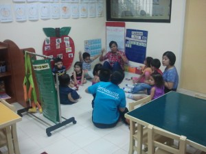 listening to the story read by her teacher