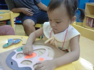 Playing with puzzles.  She played with puzzles on the first day