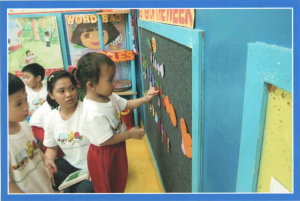 Ria putting something on the board